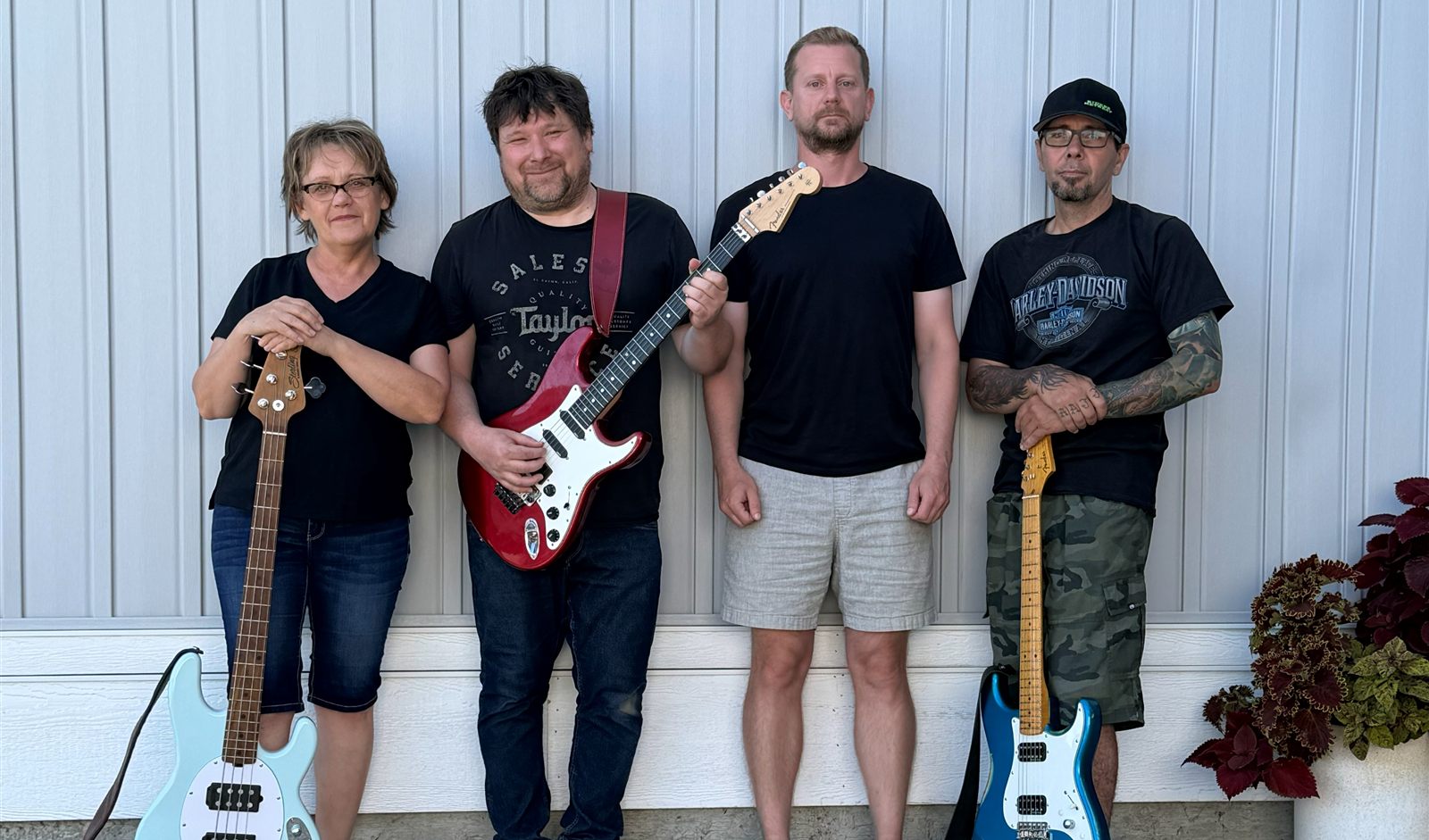 The four members of They Killed Kenny with their guitars
